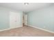 Empty bedroom with carpet, closet, and access to other rooms at 6925 Rex Rd, Holly Springs, NC 27540