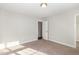 Bedroom featuring neutral walls and carpet, open door leading to other room, and natural light at 6925 Rex Rd, Holly Springs, NC 27540