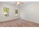 Bright and airy bedroom with neutral walls and carpet, and views to the outdoors through two windows at 6925 Rex Rd, Holly Springs, NC 27540