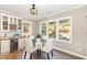 Cozy dining area with ample natural light, a beverage fridge, and stylish decor at 6925 Rex Rd, Holly Springs, NC 27540