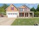 Charming two-story home featuring a two-car garage, red shutters, and a well-maintained lawn at 6925 Rex Rd, Holly Springs, NC 27540