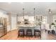 Modern kitchen features a large island, stainless steel appliances, and adjacent dining area at 6925 Rex Rd, Holly Springs, NC 27540