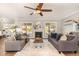 Spacious living room featuring a fireplace, large windows, and comfortable seating at 6925 Rex Rd, Holly Springs, NC 27540