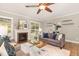 Cozy living room featuring a fireplace, large windows, and comfortable seating at 6925 Rex Rd, Holly Springs, NC 27540
