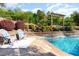 Inviting pool area with lounge chairs and beautiful landscaping, perfect for relaxation and outdoor enjoyment at 6925 Rex Rd, Holly Springs, NC 27540