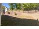 Landscaped backyard featuring terraced retaining walls and metal fence at 705 Blue Pointe Path, Apex, NC 27523