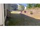 View of the backyard with sloped, terraced landscaping and rear of the house at 705 Blue Pointe Path, Apex, NC 27523