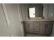 Contemporary bathroom features a double sink vanity with gray cabinets and modern fixtures at 705 Blue Pointe Path, Apex, NC 27523