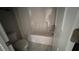 Bathroom featuring marble-tiled floors, a toilet, and a tub at 705 Blue Pointe Path, Apex, NC 27523