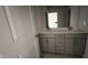 Bathroom featuring double sink vanity with grey cabinets and white countertop at 705 Blue Pointe Path, Apex, NC 27523