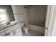 Bathroom features a vanity, toilet and tub/shower combination with neutral walls and luxury vinyl tile flooring at 705 Blue Pointe Path, Apex, NC 27523