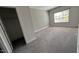 View into a bedroom with carpet, a closet and neutral colored walls with painted trim and a window at 705 Blue Pointe Path, Apex, NC 27523