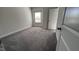 Bedroom with a window letting in natural light, carpet and neutral colored walls with white painted trim at 705 Blue Pointe Path, Apex, NC 27523
