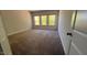 Well-lit bedroom with neutral walls, three large windows, and plush carpeting, perfect for relaxation at 705 Blue Pointe Path, Apex, NC 27523