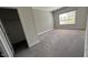 A bedroom with neutral walls, plush carpeting, closet with door, and window offering a cozy retreat at 705 Blue Pointe Path, Apex, NC 27523
