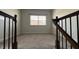 The bonus room features neutral carpeting, a window for natural light and black iron railing at 705 Blue Pointe Path, Apex, NC 27523