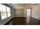 Dining room featuring dark hardwood floors, tray ceiling, and natural light at 705 Blue Pointe Path, Apex, NC 27523