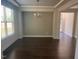 Dining room featuring dark hardwood floors, tray ceiling, and natural light at 705 Blue Pointe Path, Apex, NC 27523