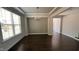 Bright dining room featuring hardwood floors, a classic chandelier, and ample natural light from a large window at 705 Blue Pointe Path, Apex, NC 27523