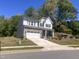 Beautiful two-story home with a stone-accented garage and a well-manicured front lawn at 705 Blue Pointe Path, Apex, NC 27523