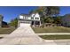 Charming two-story home featuring a stone-accented garage and a long driveway leading to the street at 705 Blue Pointe Path, Apex, NC 27523