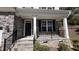 Inviting front porch with stone details, black railings, and the house number on display at 705 Blue Pointe Path, Apex, NC 27523