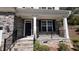 Inviting front porch with stone accents, black railings, and white columns at 705 Blue Pointe Path, Apex, NC 27523