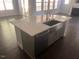Kitchen island with stainless steel sink and appliances at 705 Blue Pointe Path, Apex, NC 27523