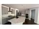 Modern kitchen with stainless steel appliances, gray cabinets, and a kitchen island at 705 Blue Pointe Path, Apex, NC 27523