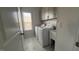 Laundry room with white washer and dryer, white cabinets and luxury vinyl tile flooring at 705 Blue Pointe Path, Apex, NC 27523