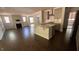 Open-concept living room with hardwood floors, a fireplace, and ample natural light at 705 Blue Pointe Path, Apex, NC 27523