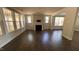 Spacious living room with a fireplace, lots of natural light, and dark hardwood floors at 705 Blue Pointe Path, Apex, NC 27523