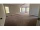 Spacious primary bedroom featuring gray carpet and three windows with blinds at 705 Blue Pointe Path, Apex, NC 27523