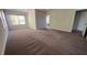 Spacious primary bedroom featuring gray carpet and three windows with blinds at 705 Blue Pointe Path, Apex, NC 27523