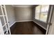Cozy office space with hardwood flooring, bright natural light, and a glass door entrance at 705 Blue Pointe Path, Apex, NC 27523