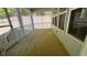 Spacious screened-in porch features a wooden floor and a peaceful view of the yard at 705 Blue Pointe Path, Apex, NC 27523