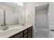 Bright bathroom features a double sink vanity with dark wood cabinets and a shower-tub combination at 7104 Rex Rd, Holly Springs, NC 27540