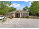 Exterior view of the community clubhouse with parking and nearby amenities at 7104 Rex Rd, Holly Springs, NC 27540
