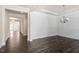 Bright dining room with modern chandelier, shiplap accent wall and dark hardwood floors at 7104 Rex Rd, Holly Springs, NC 27540