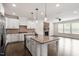 Gourmet kitchen with stone backsplash, stainless appliances, an island, and an open floor plan at 7104 Rex Rd, Holly Springs, NC 27540