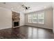 Living room featuring a cozy fireplace, large windows, and dark hardwood floors at 7104 Rex Rd, Holly Springs, NC 27540