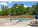 Community pool surrounded by lounge chairs and umbrellas on a sunny day at 7104 Rex Rd, Holly Springs, NC 27540