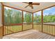 View from screened porch overlooking the back yard, surrounded by green trees at 7104 Rex Rd, Holly Springs, NC 27540