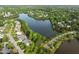 Aerial view of a serene lake surrounded by upscale homes and lush greenery, creating a peaceful waterfront community at 712 Portstewart Dr, Cary, NC 27519