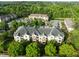An aerial view showcasing the community's well-maintained buildings, lush trees, and ample parking at 712 Portstewart Dr, Cary, NC 27519