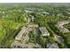 Aerial view captures residential homes nestled around a lake in a wooded community at 712 Portstewart Dr, Cary, NC 27519