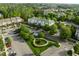 Aerial view showcasing community buildings, manicured lawns, and ample parking in a serene, park-like setting at 712 Portstewart Dr, Cary, NC 27519