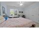 Bright bedroom with a ceiling fan, a large window for natural light and closet at 712 Portstewart Dr, Cary, NC 27519