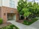 Inviting brick building entrance featuring a covered walkway and well-maintained landscaping at 712 Portstewart Dr, Cary, NC 27519