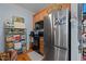 Kitchen with stainless steel refrigerator, wood cabinets, and shelving at 712 Portstewart Dr, Cary, NC 27519